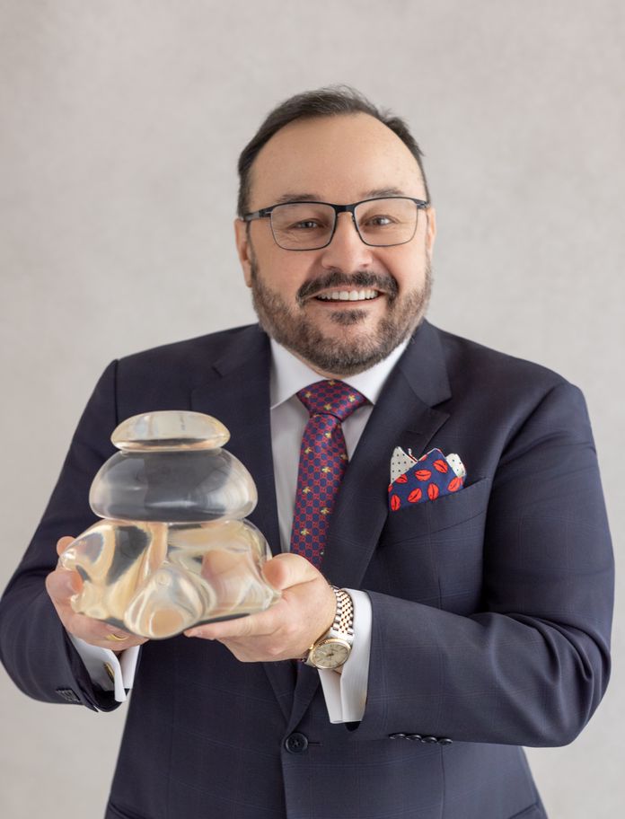 Dr. Aldo Guerra holding implants