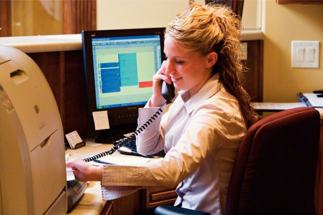 model at desk job answering phone